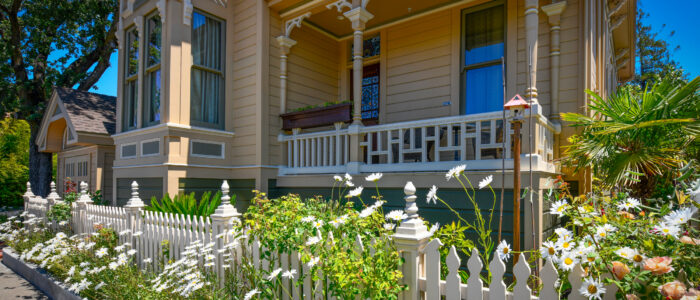 Historic Queen Anne Eastlake Front Porch and Tower Fronting on Jefferson Street. Room 10's Porch/Balcony Sits 5 Feet Above Victorian Garden with Flowers , Palms and Cycads.