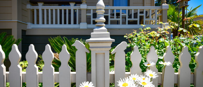 Room 10 Parch/Balcony with Garden In Front, Showing Detail of Picket Fence Having Traditional Eastlake Details and Added Bird Topped Pickets.