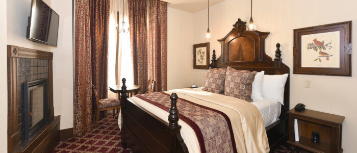 Room 11 Features Queen Bed Flanked by 2 Nightstands, and Antique Audubon Prints. Pendant Reading Lights Hang Above Bed.