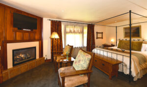 Room 4 King Bed, Chest at Foot of Bed, 2 Chairs with Table in Between, Fireplace